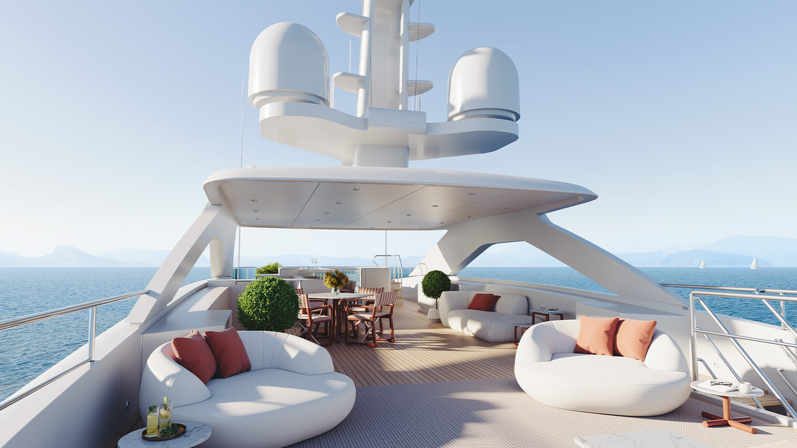 Luxurious yacht deck featuring modern seating areas with white cushioned sofas and chairs, small tables, and potted plants, set against a backdrop of a calm sea and distant sailboats.
