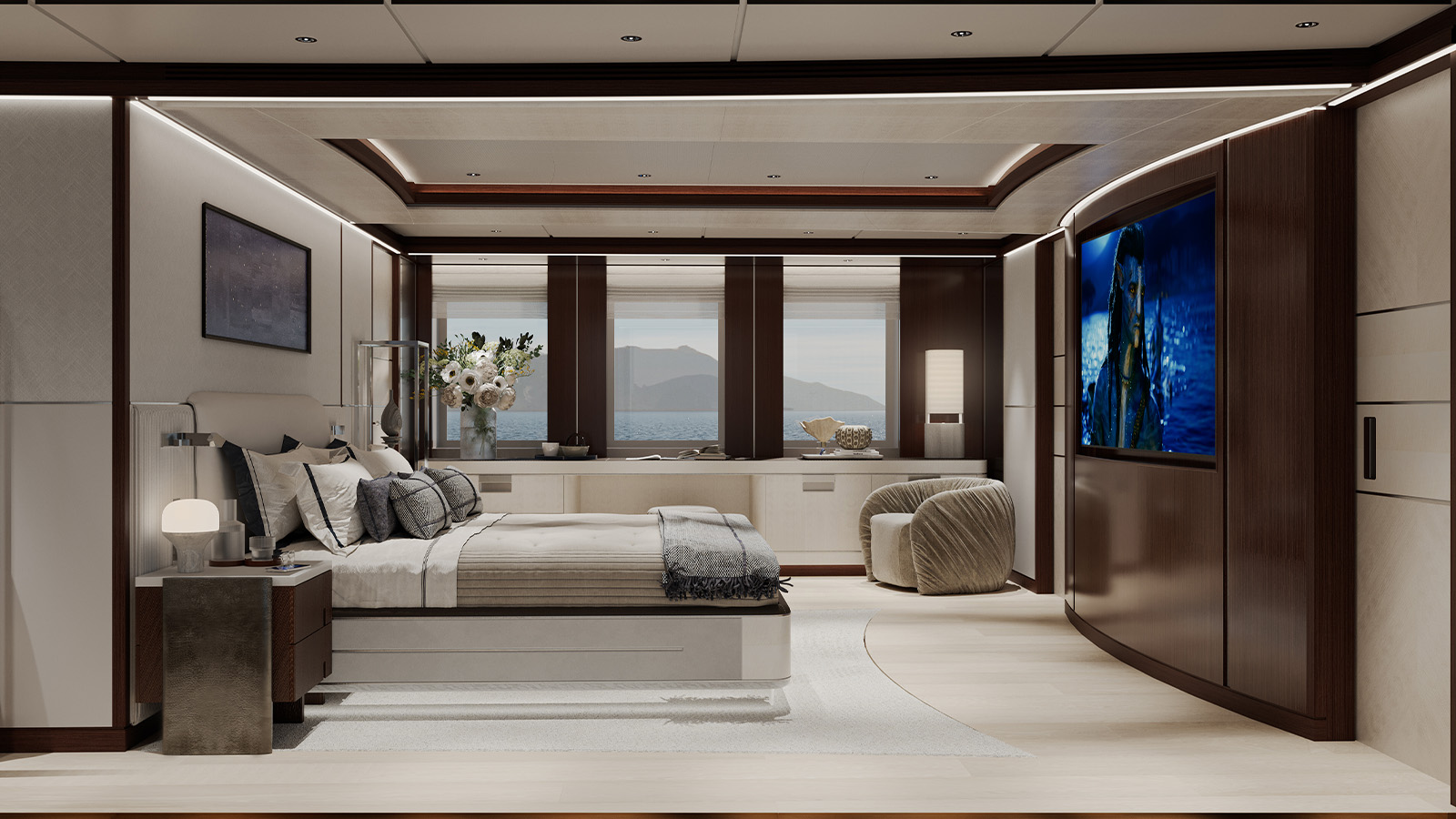 Luxurious bedroom interior with a large bed, modern decor, and a flat-screen TV mounted on a curved wooden wall. The room features wood and neutral tones, a plush armchair, and large windows revealing a view of the sea and mountains.