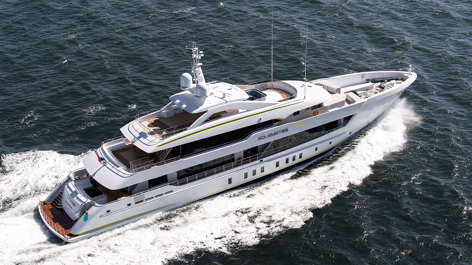 A luxurious white yacht named 'Solemates' cruising on open water, featuring multiple decks and modern amenities.