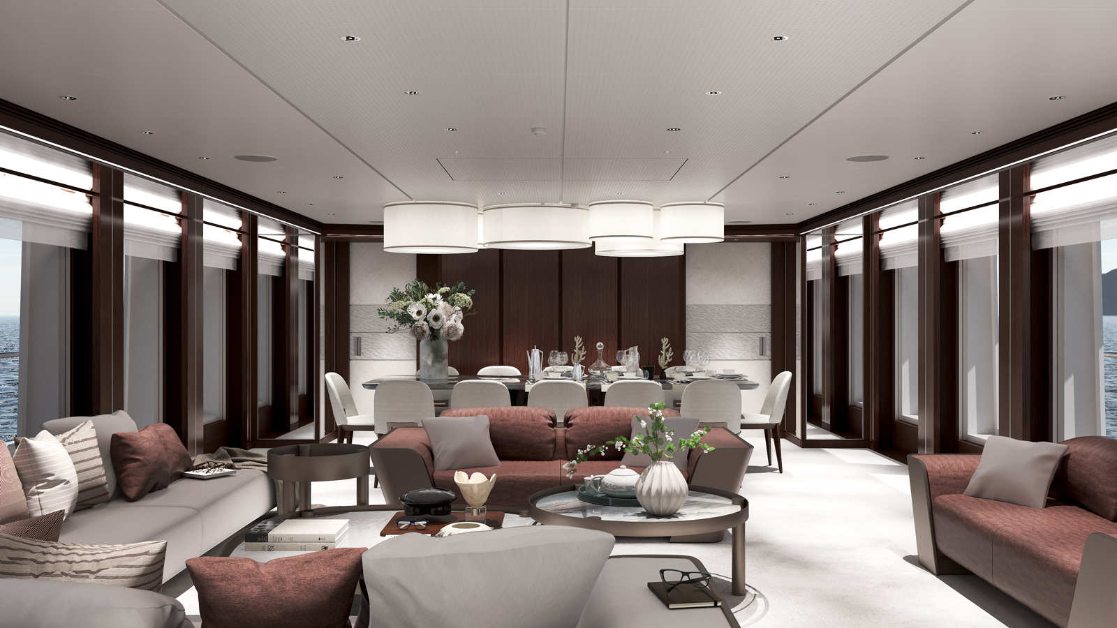 Luxurious yacht interior with elegant furnishings, featuring a dining table with chairs and floral centerpiece, surrounded by plush sofas and armchairs in a spacious, well-lit room with large windows displaying an ocean view.