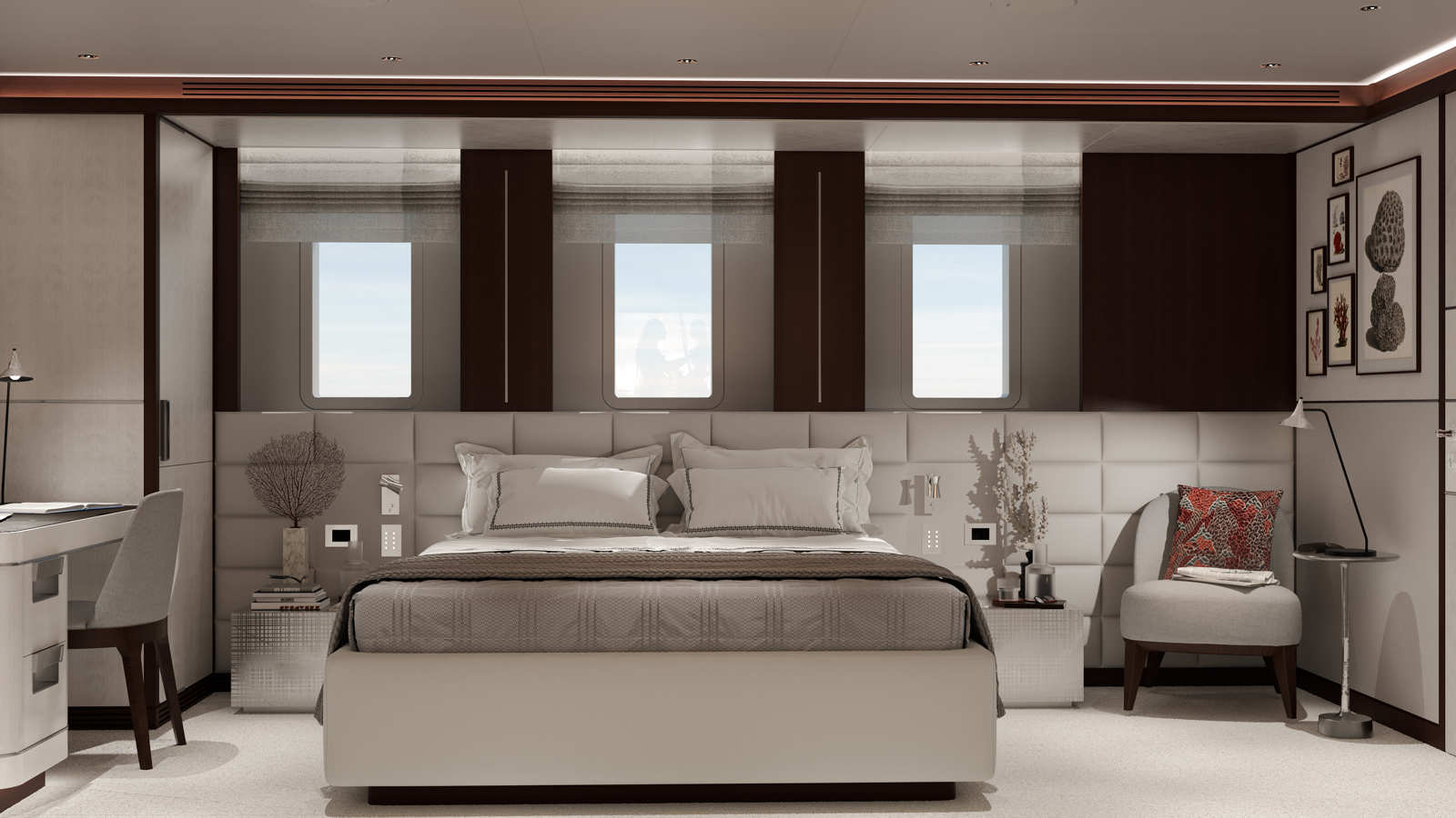 Luxurious bedroom with a large bed, cushioned headboard, two windows, a desk with a chair, a small side table with decorative items, an armchair with a colorful pillow, and framed artwork on the wall.