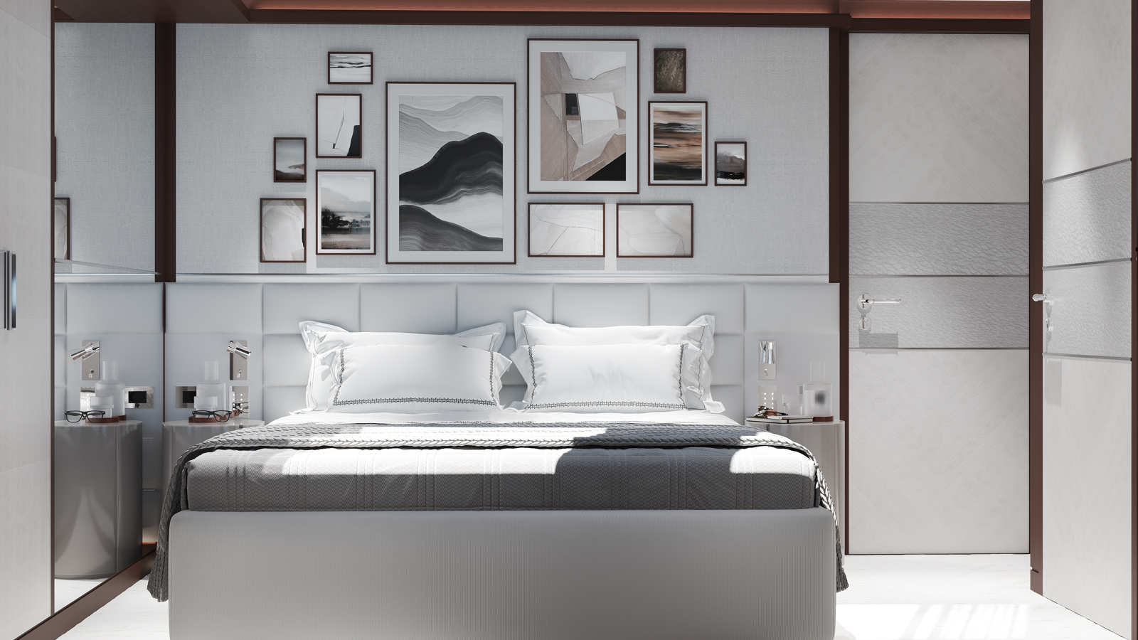 A modern bedroom featuring a neatly made bed with white and gray bedding, flanked by matching nightstands with lamps. The wall behind the bed displays a gallery of abstract artworks in various frames, adding a sophisticated touch to the minimalist decor.